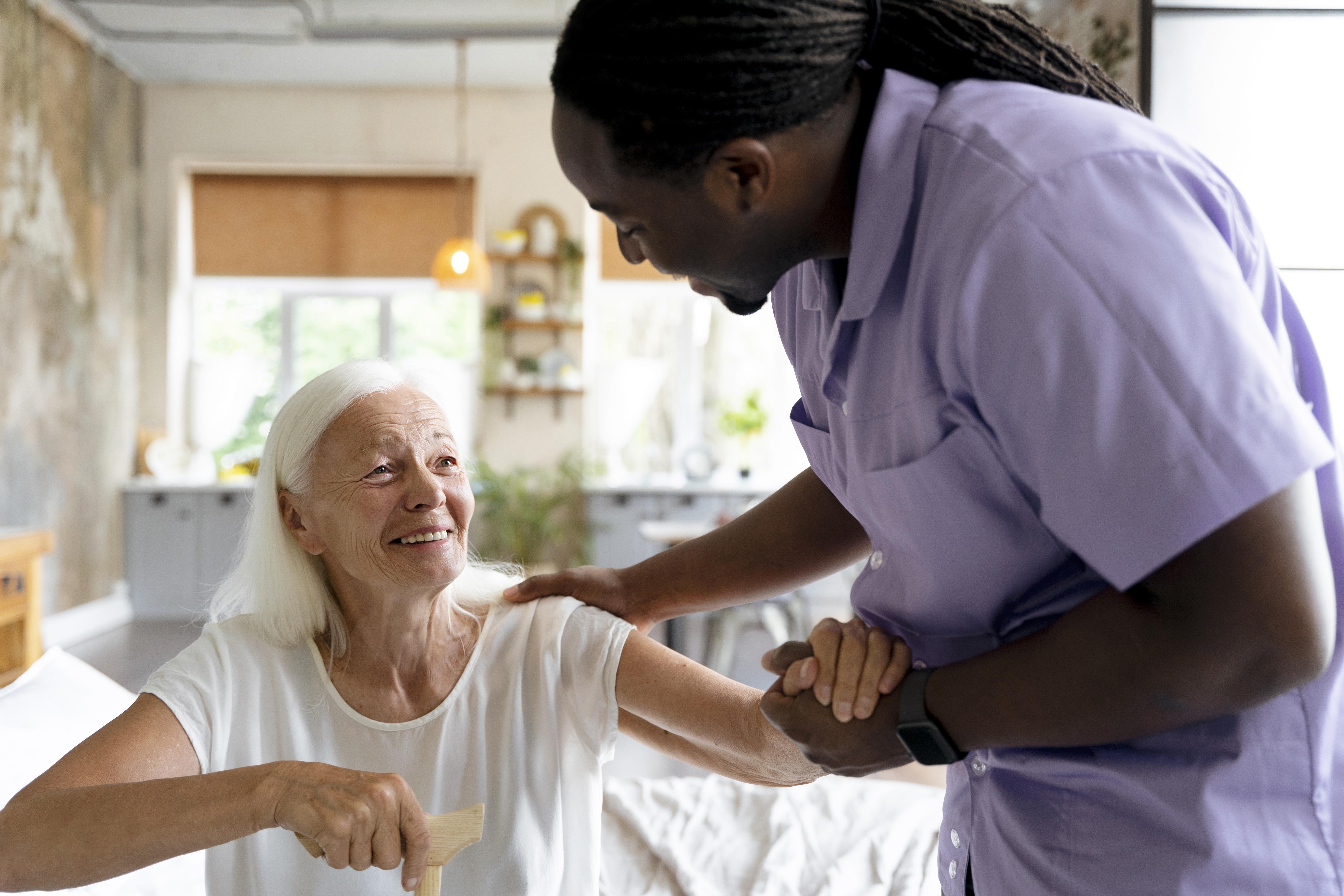Caregiver providing compassionate support to an elderly woman at home.
